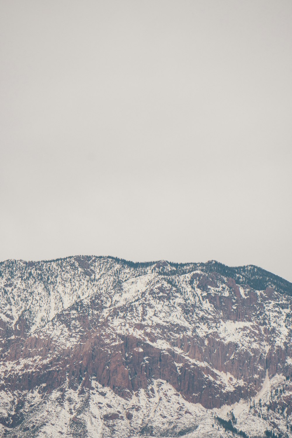 a snow covered mountain with a sky background