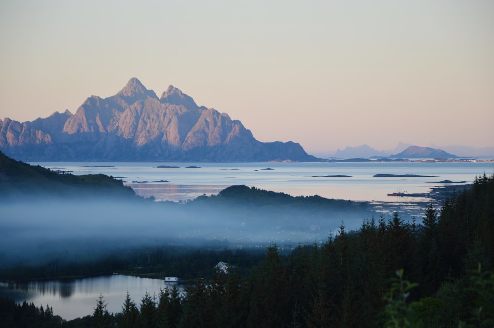 a view of a mountain range with a lake in the foreground