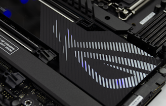 Close-up of high-tech computer hardware components with traditional African patterns subtly integrated in the background.