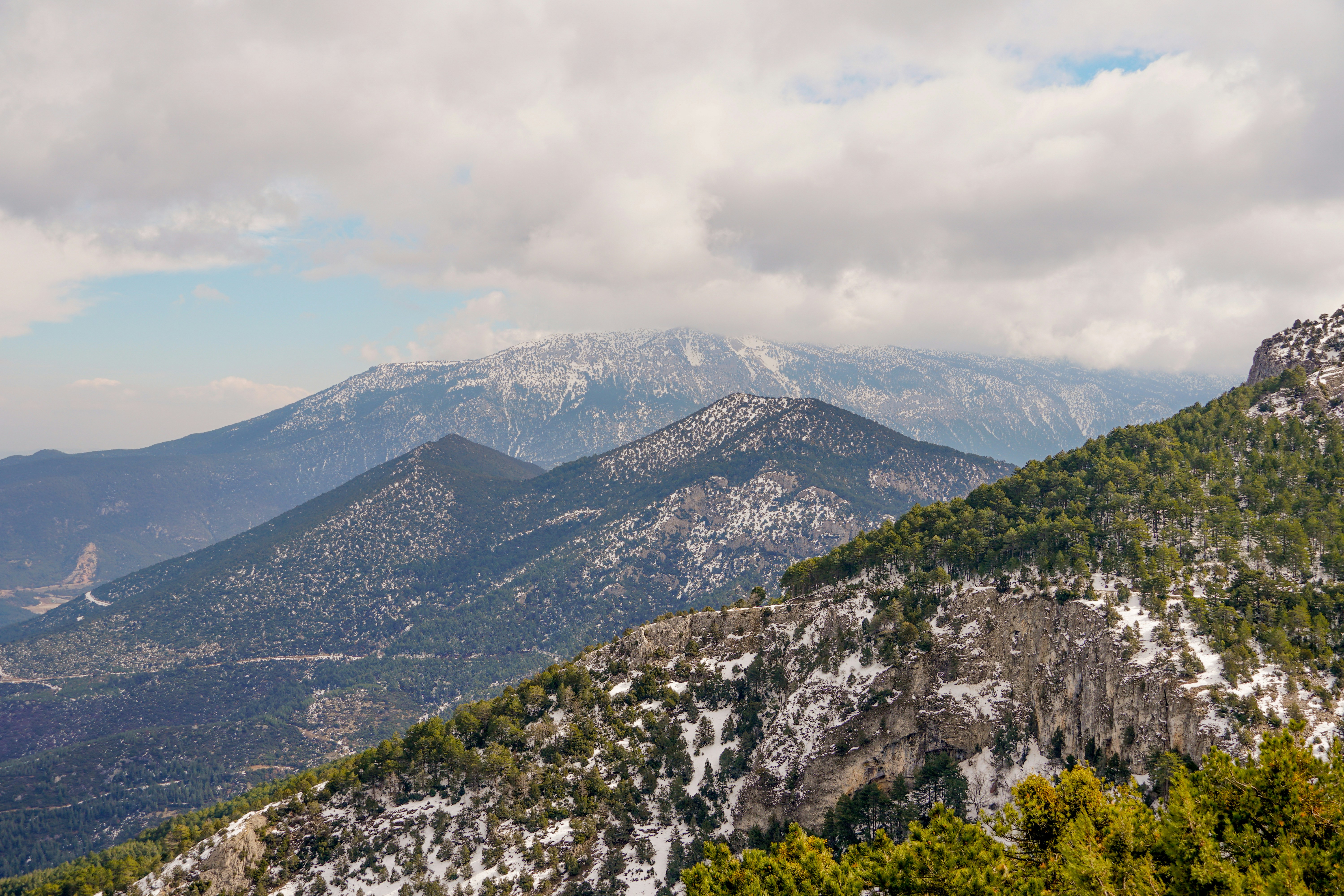 A view of a mountain range with trees and mountains in the background ...