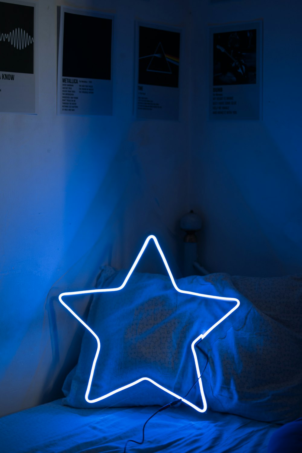 a bed with a star shaped light up pillow on top of it