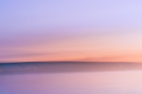 A blurry photo of a sunset over a body of water