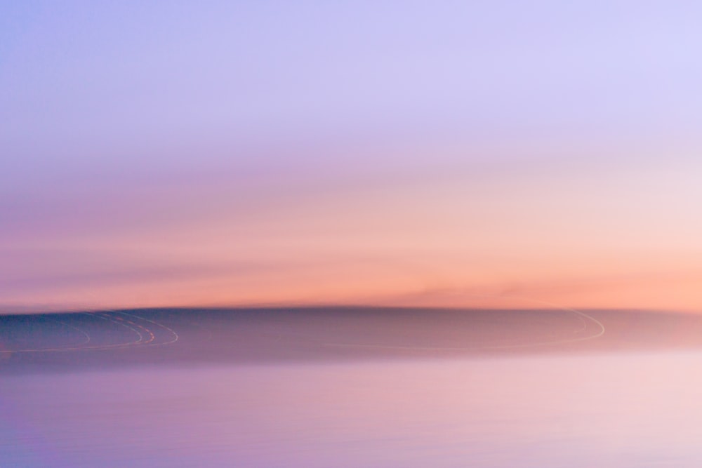 a blurry photo of a sunset over a body of water