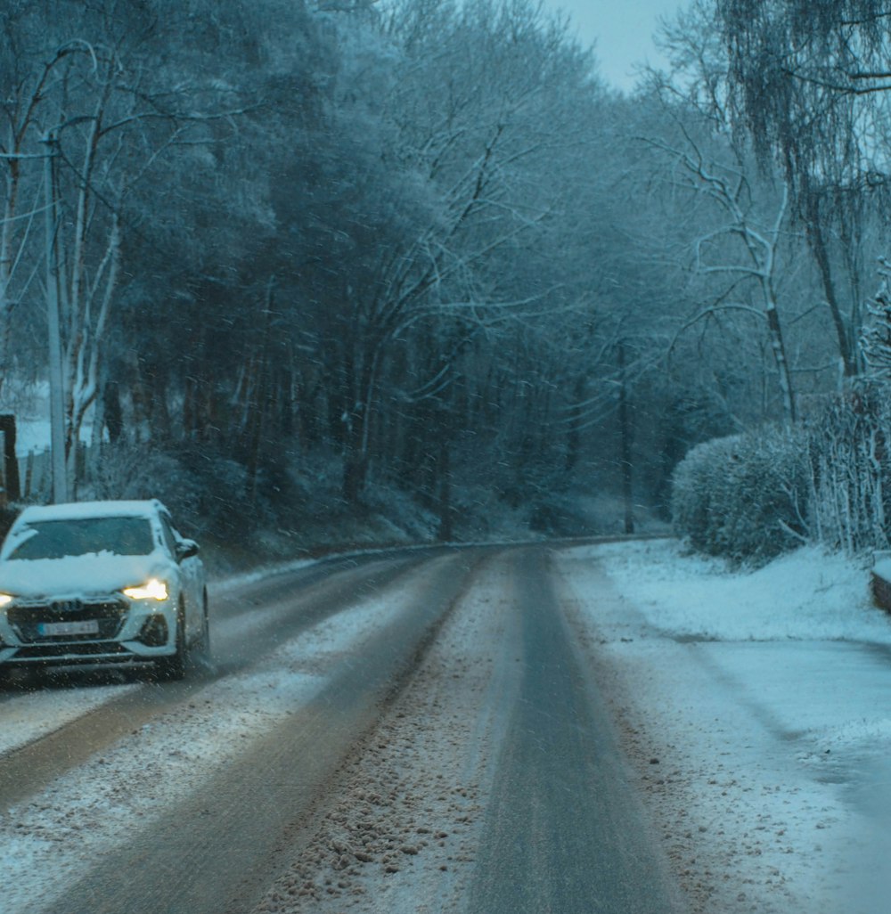 a car driving down a snow covered road