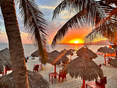Sunset view over the vibrant beach with colorful umbrellas and lively guests