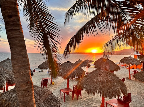 A vibrant scene of travelers enjoying a picturesque sunset on a beach included in a holiday package.