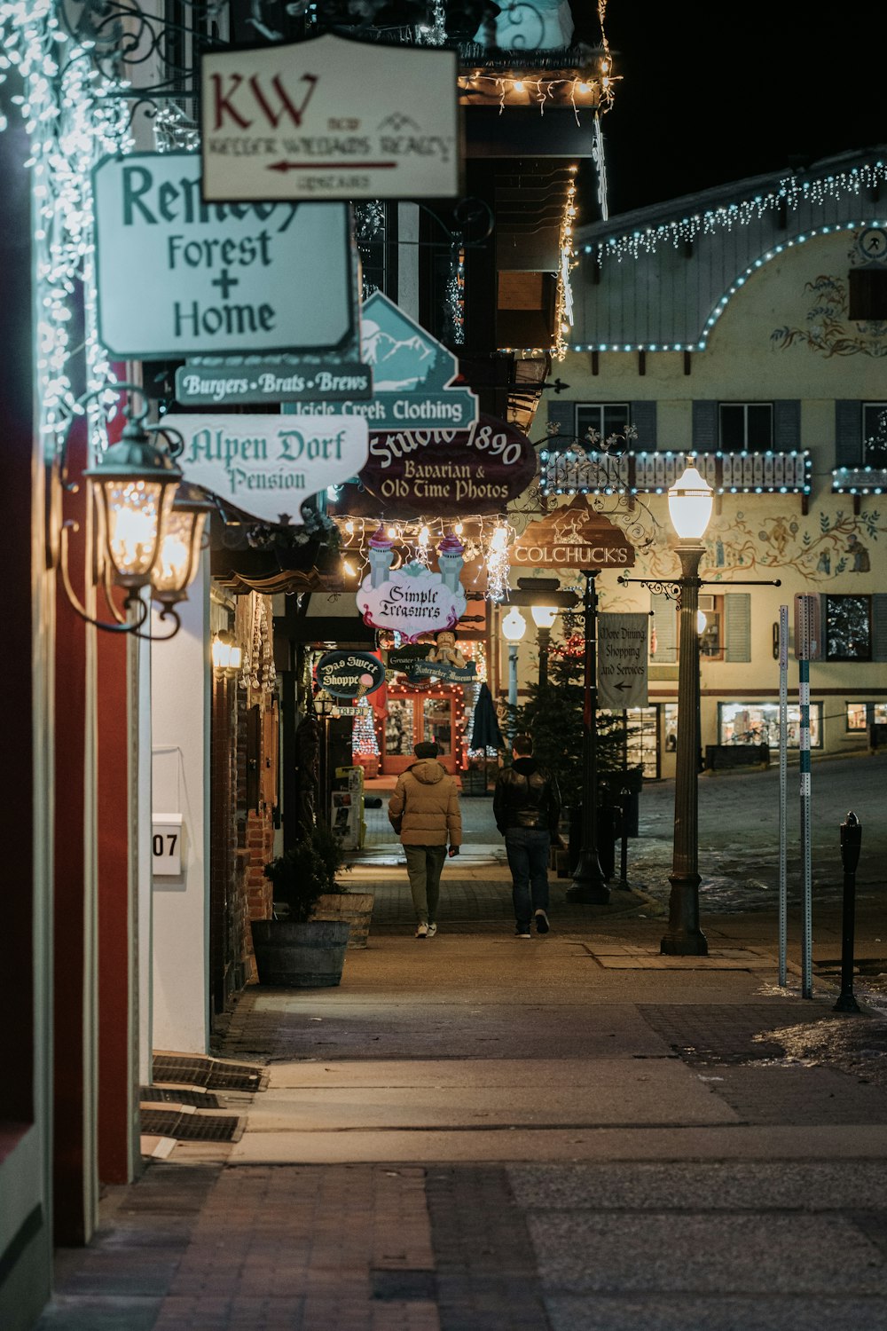 a person walking down a street at night