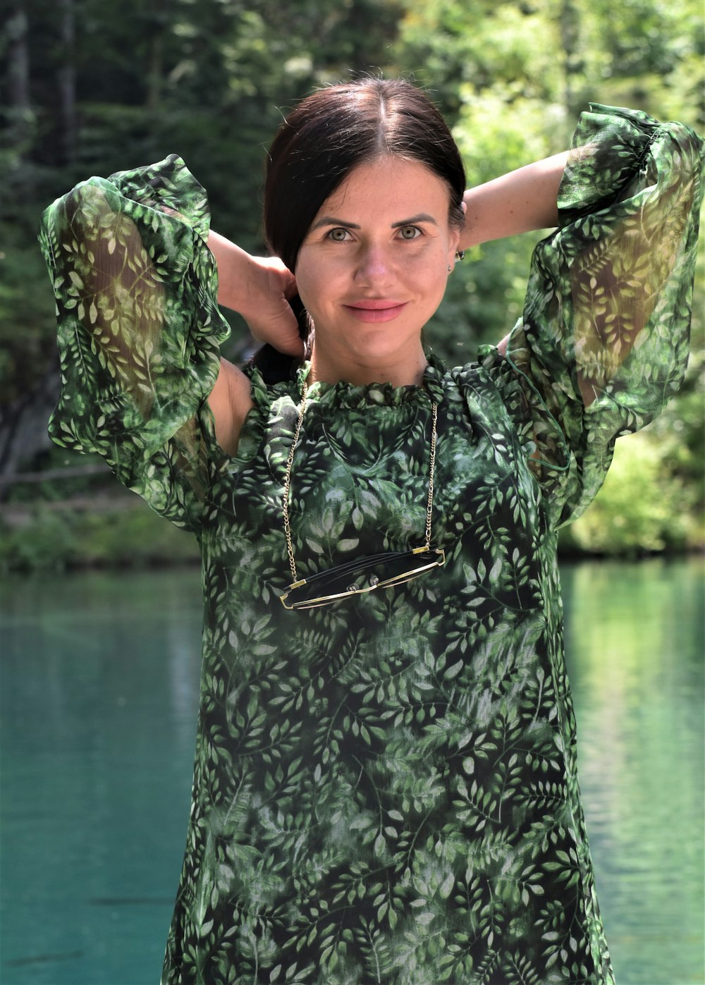 a woman standing in front of a body of water