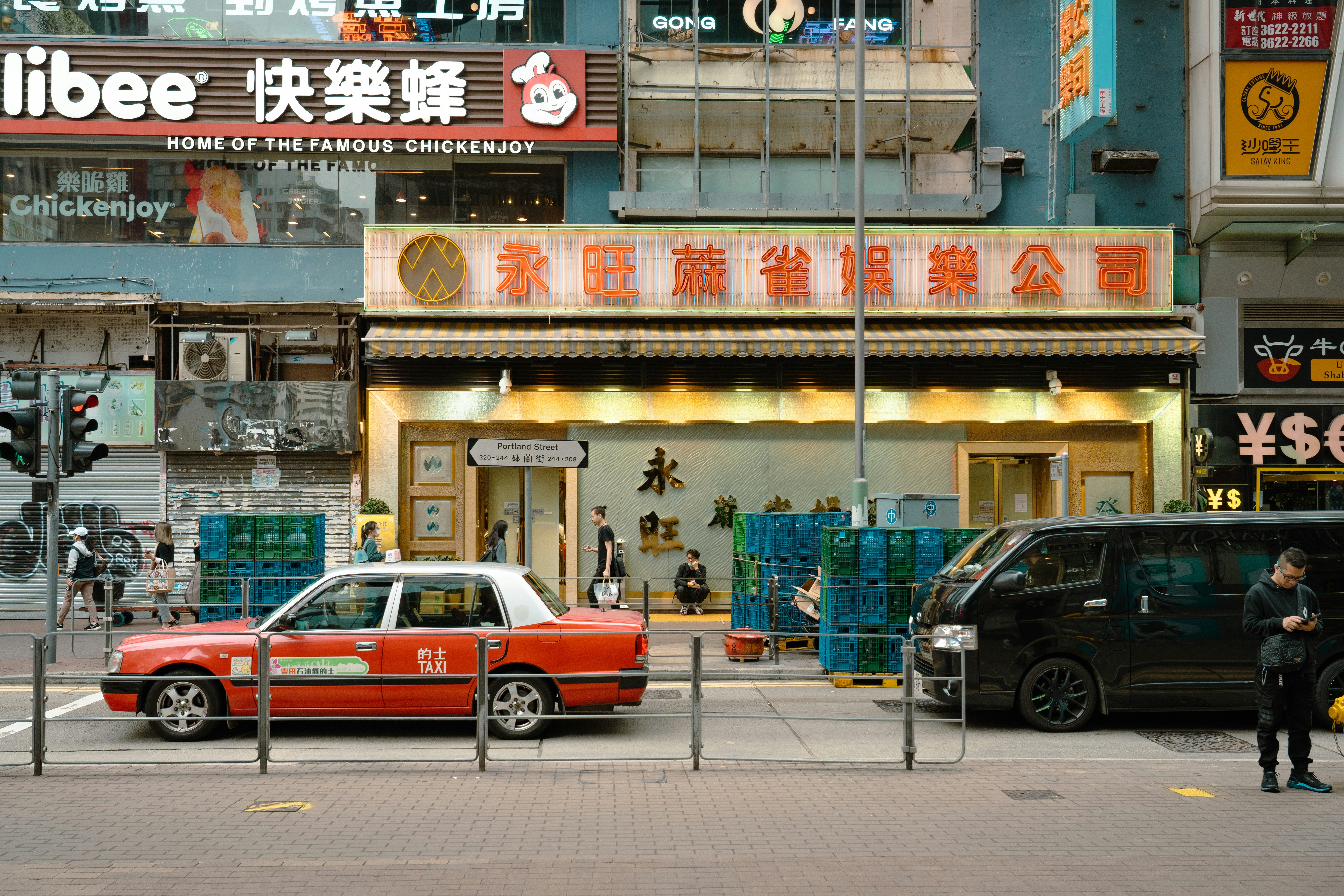 Family comparing used cars on a lot, discussing options for a first car