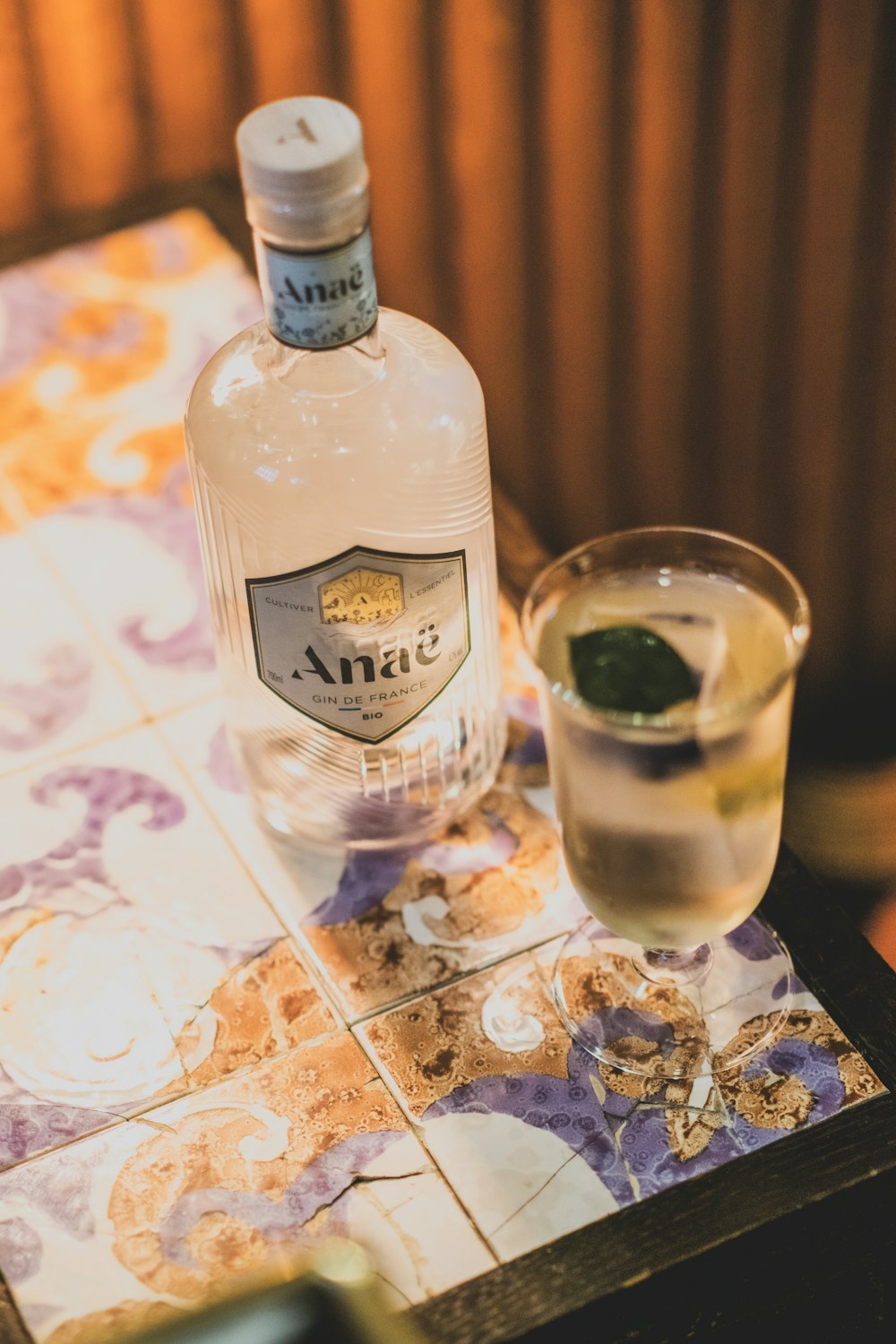 a bottle of alcohol and a glass on a table