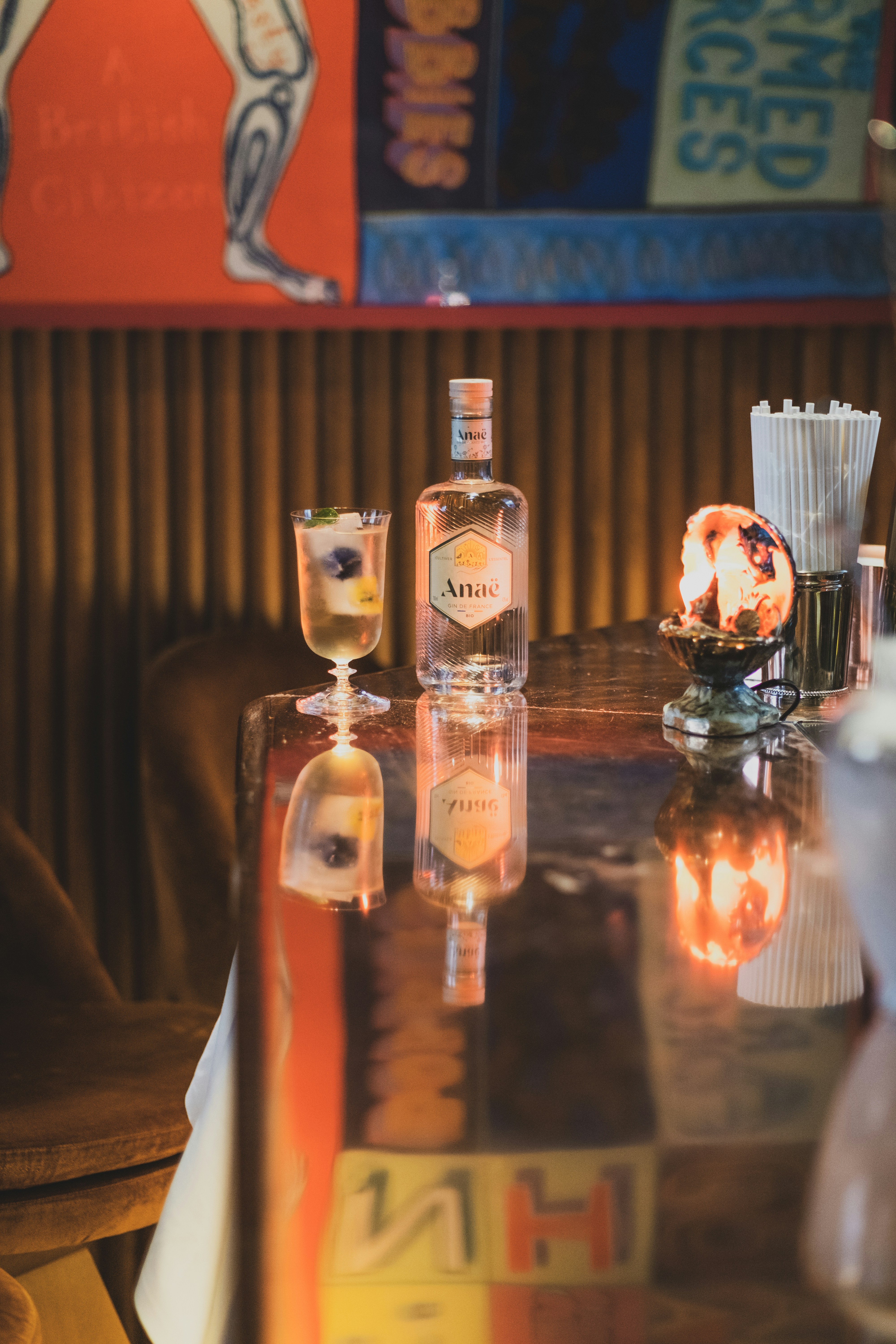 a table topped with a bottle of liquor and two glasses