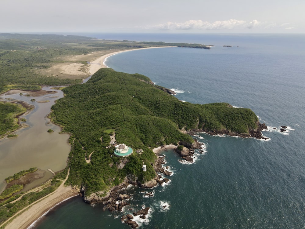 an aerial view of an island with a sandy beach