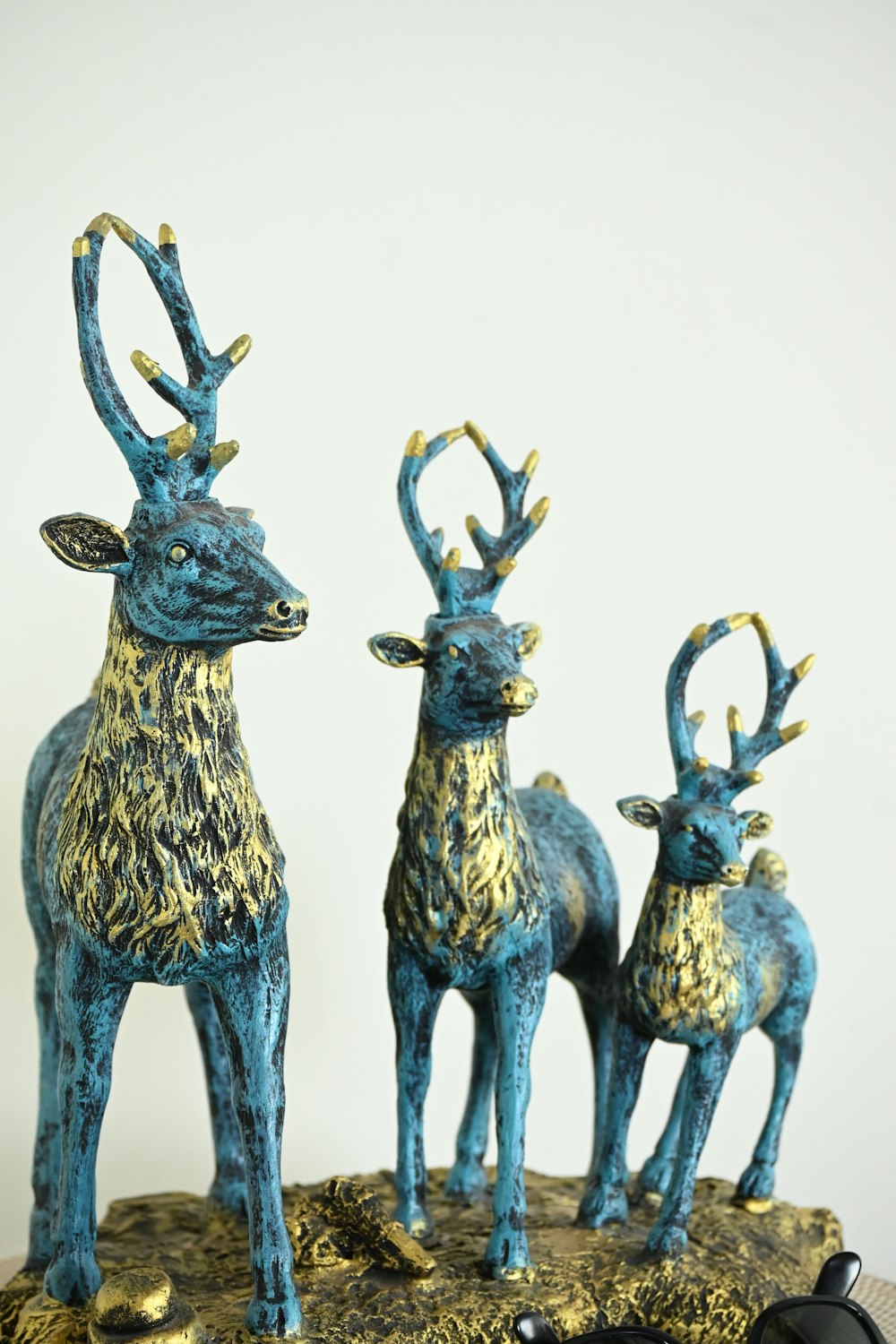 a couple of deer figurines sitting on top of a table