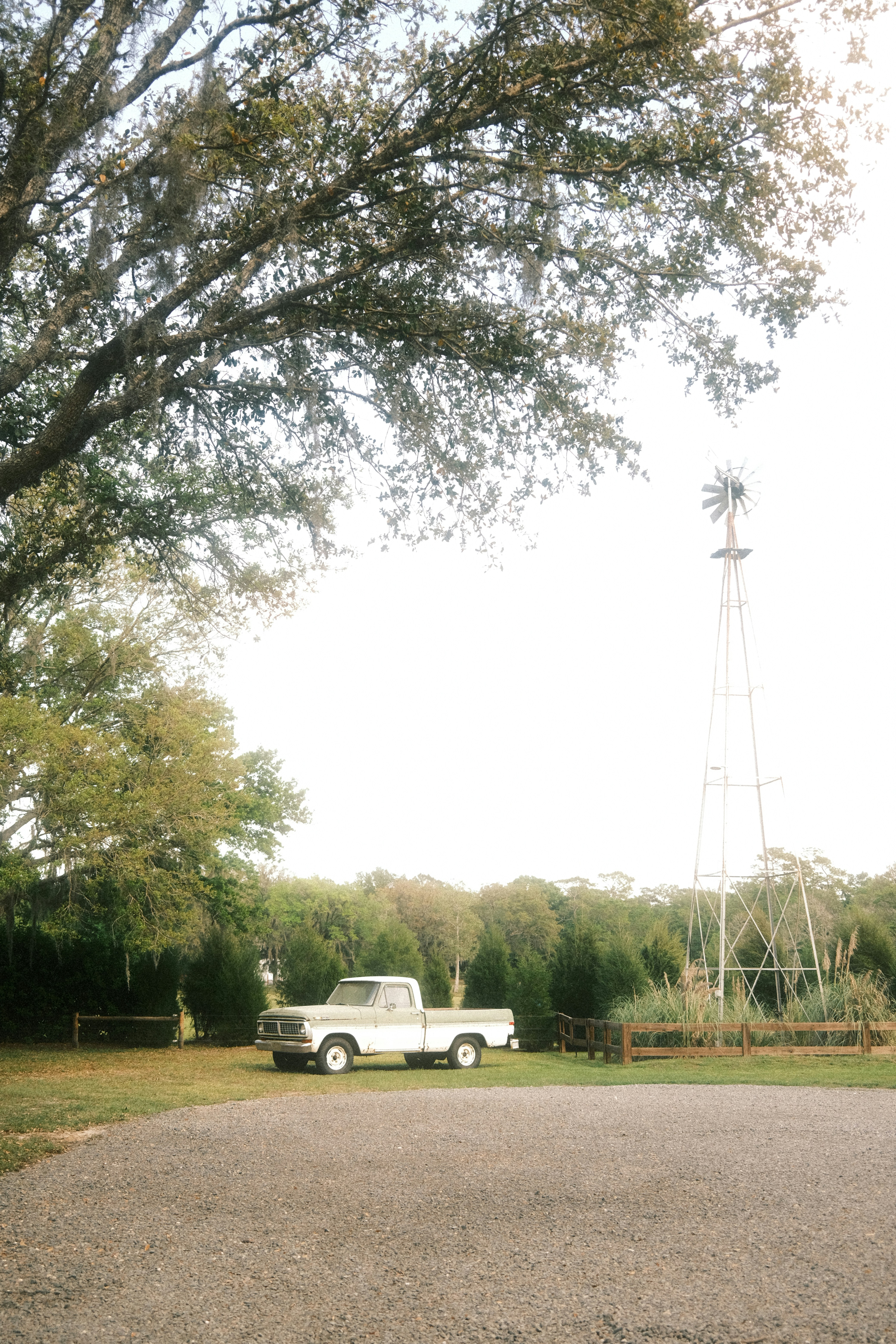 a white truck parked in front of a windmill