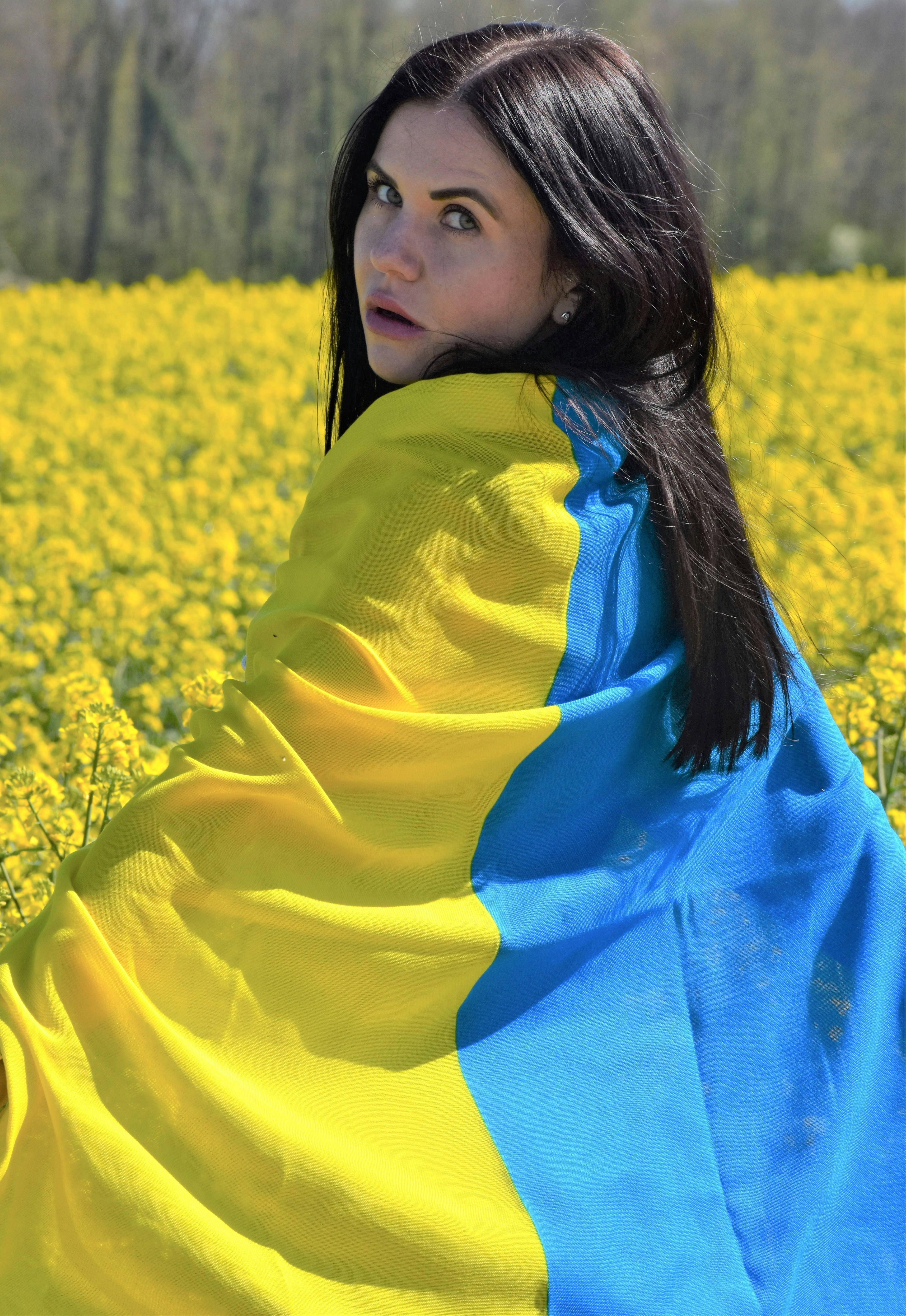 a woman sitting in a field of yellow flowers