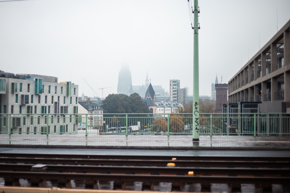 a train track with buildings in the background