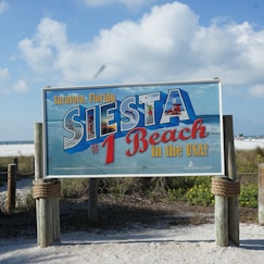 a sign for a restaurant on the beach