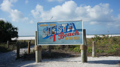 a sign for a restaurant on the beach