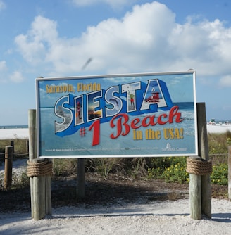 a sign for a restaurant on the beach