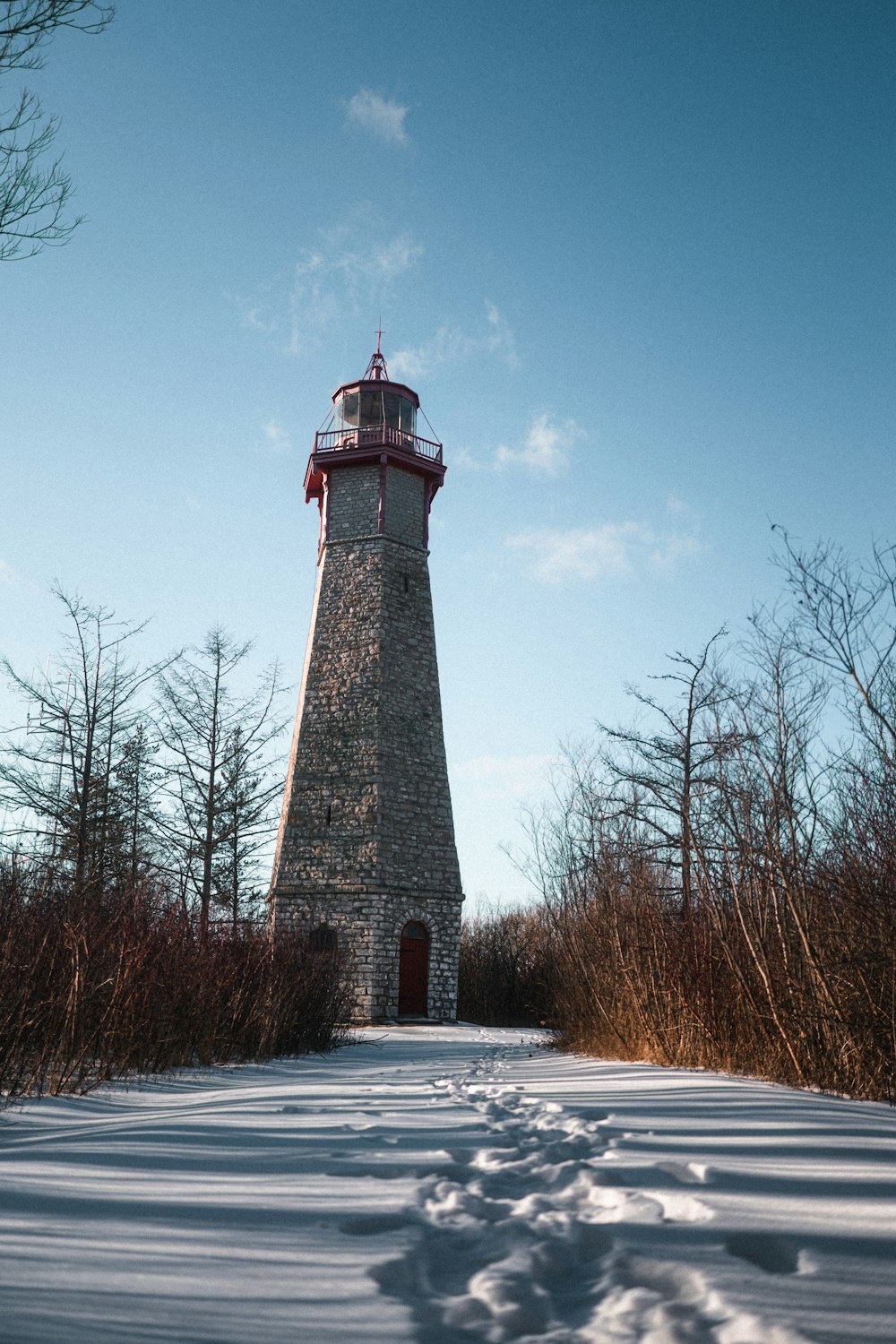 a light house in the middle of a snowy field