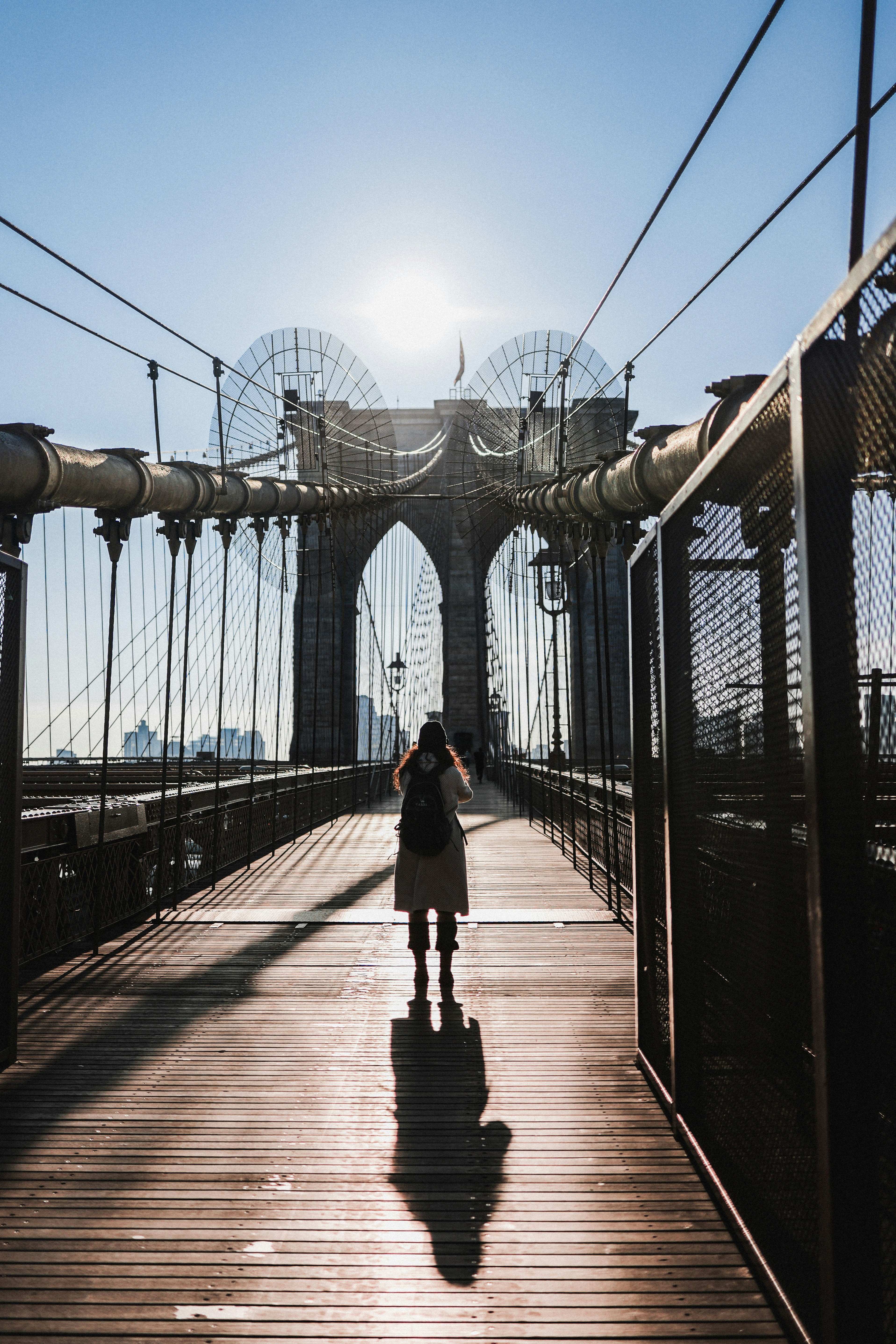 a person standing on a bridge with a backpack