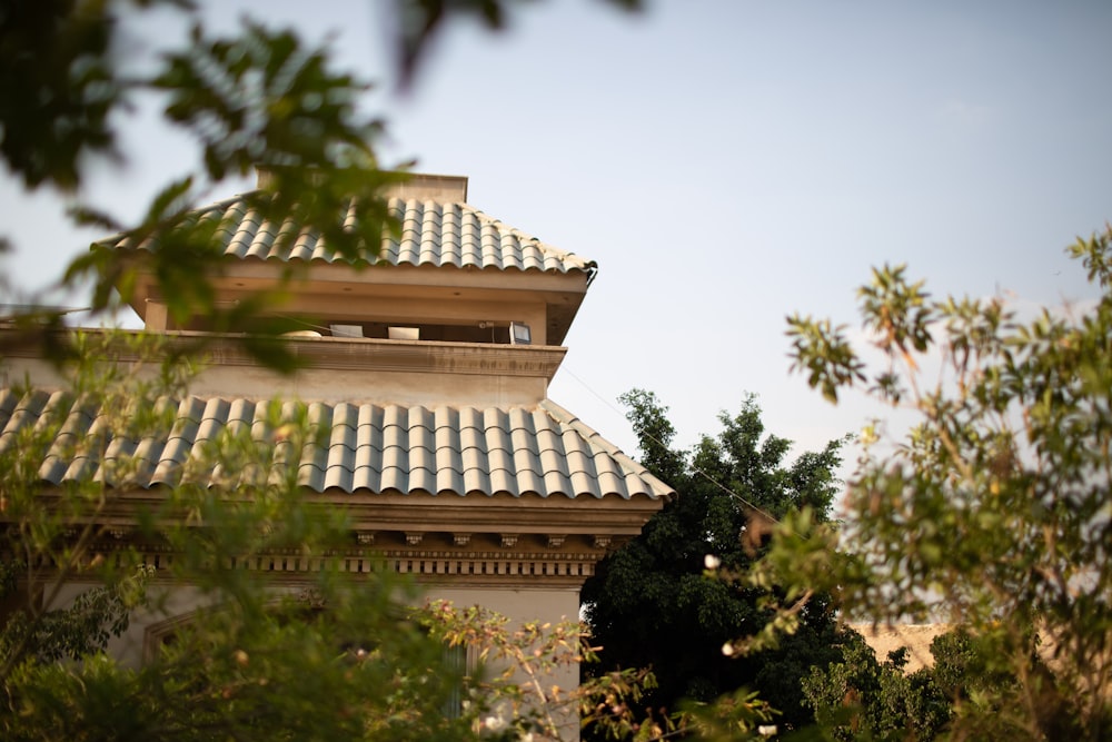 a view of a building through the leaves of a tree