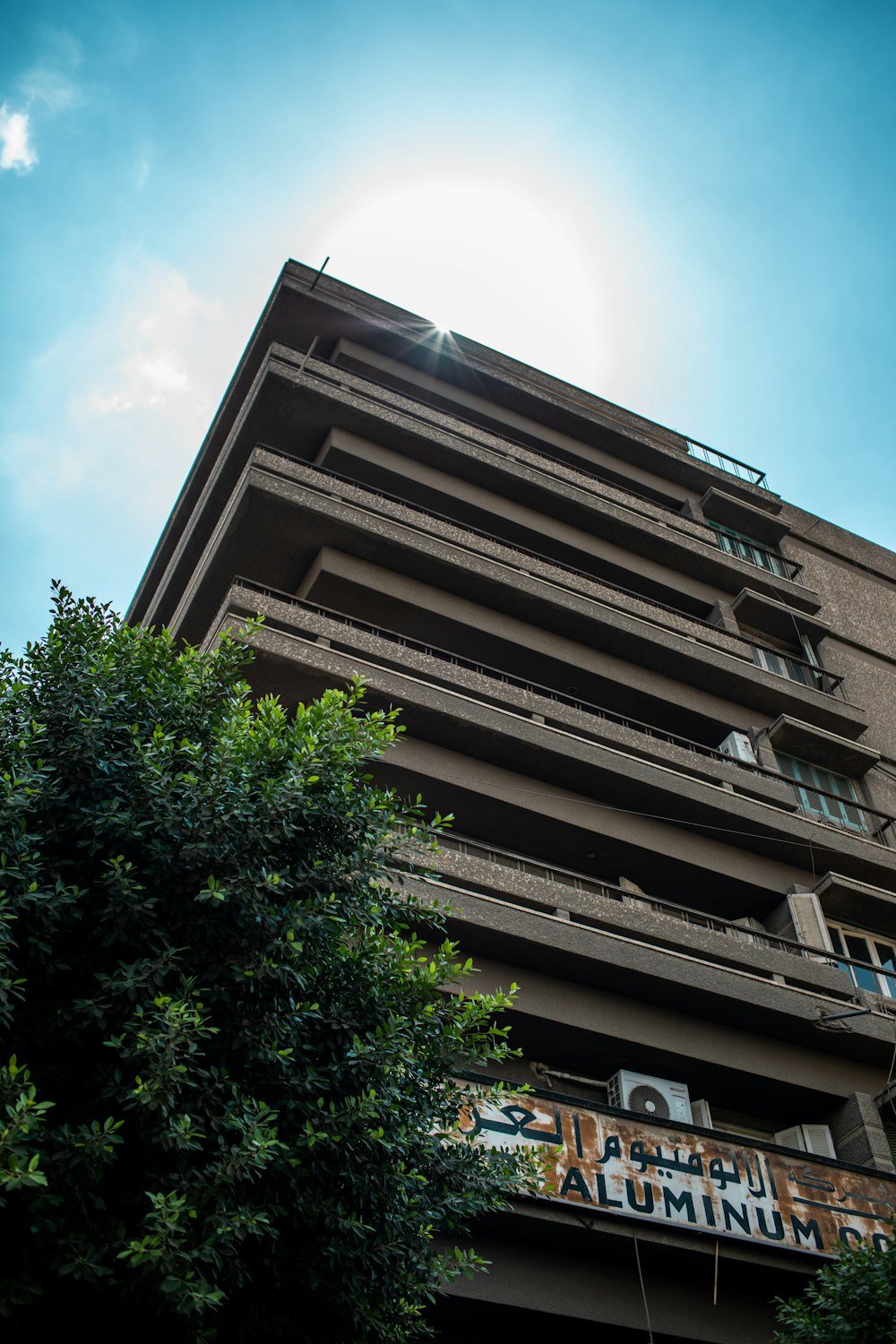 a tall building with lots of balconies on top of it