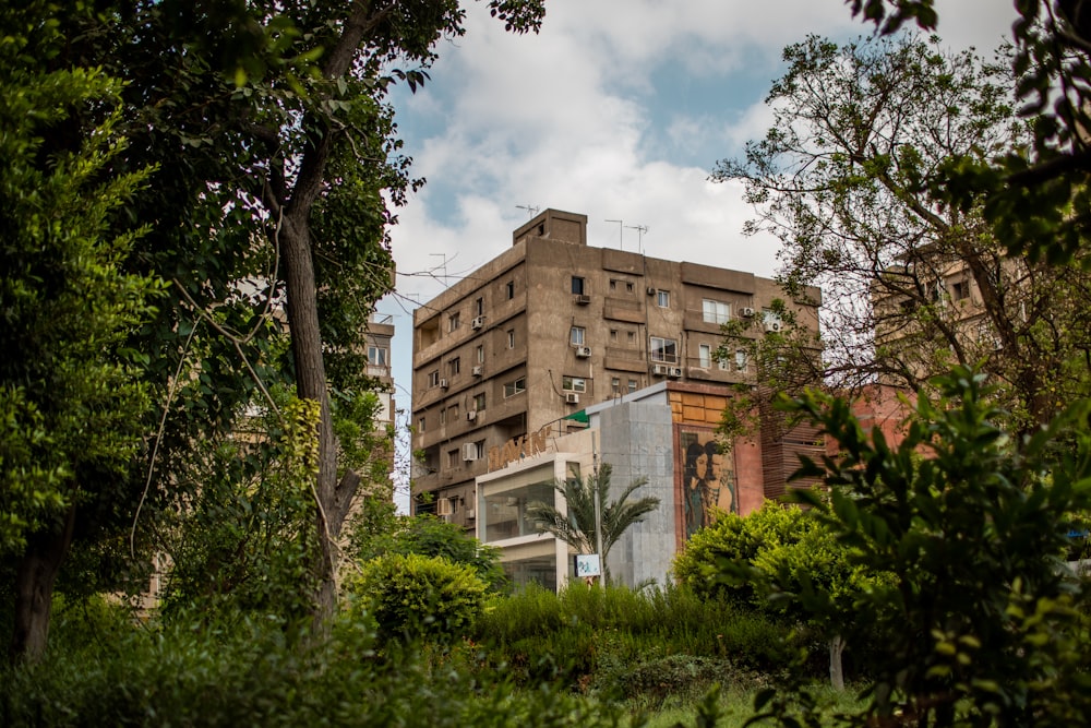 a very tall building surrounded by trees and bushes