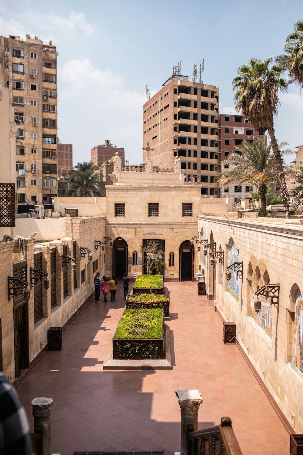 the courtyard of a building with a garden in the middle