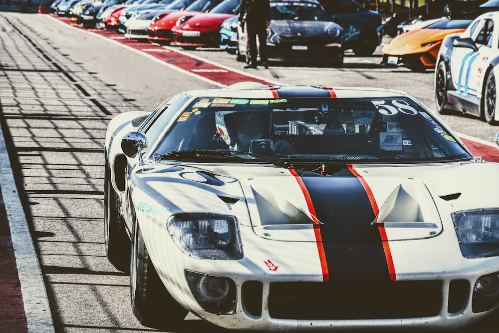 a white race car driving down a race track