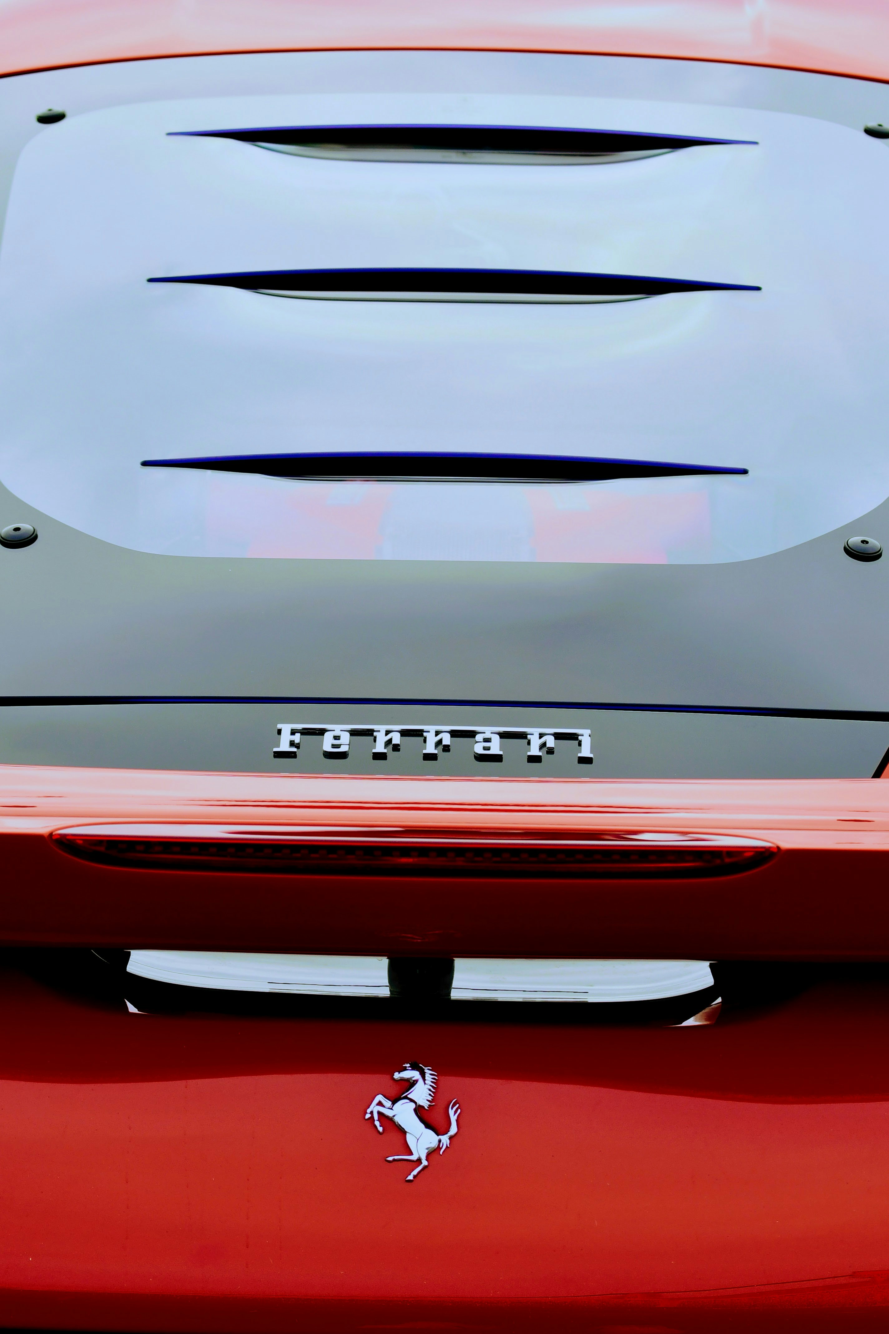 a close up of the hood of a red sports car