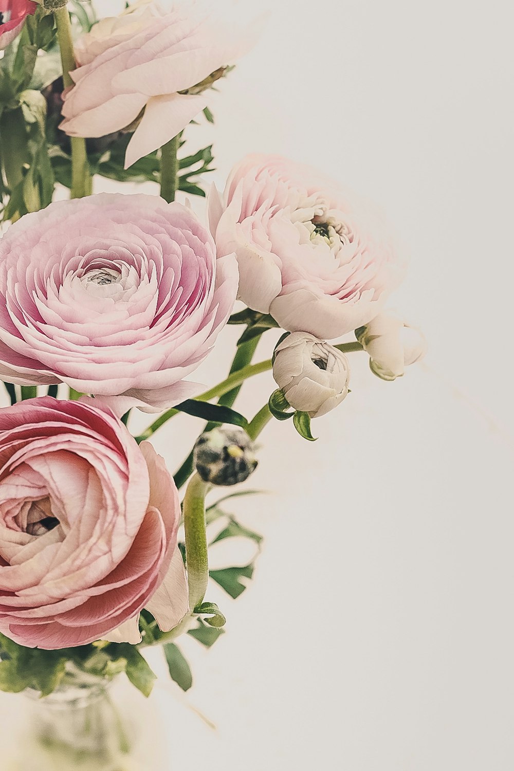 a vase filled with pink flowers on top of a table