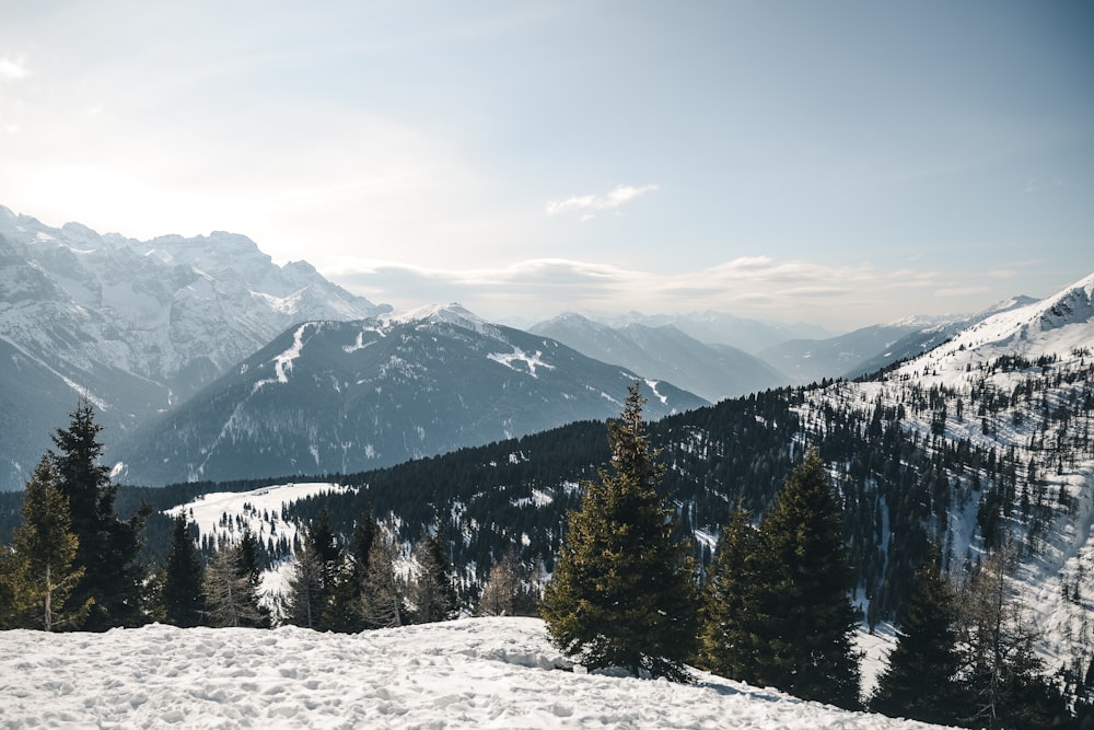 a person standing on a snow covered mountain top