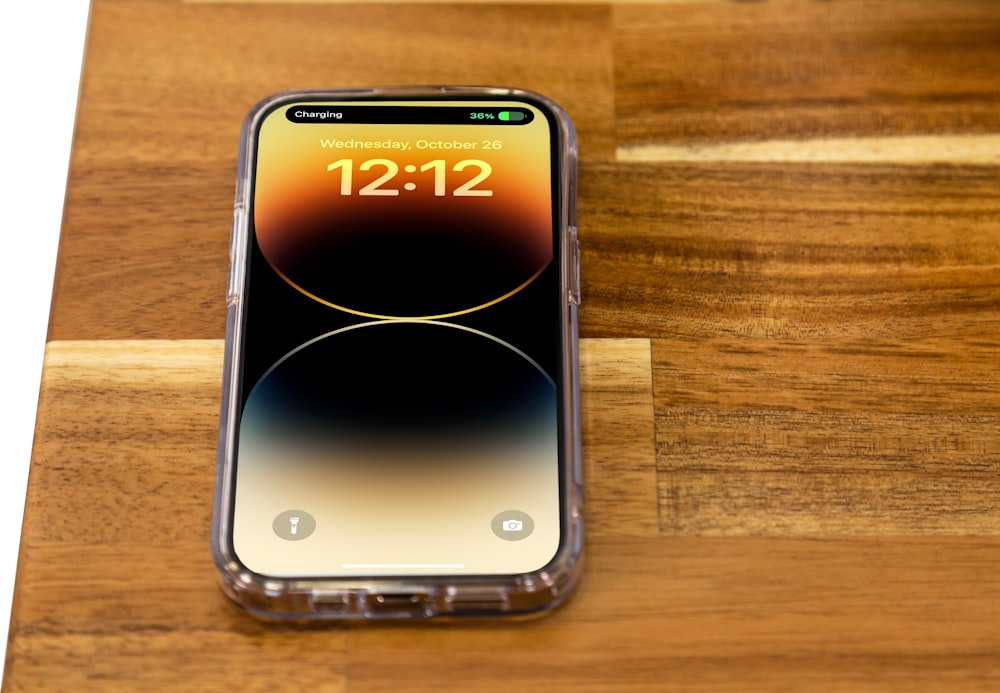 a cell phone sitting on top of a wooden table