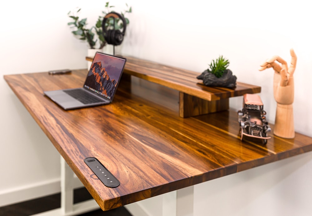 a wooden desk with a laptop on it