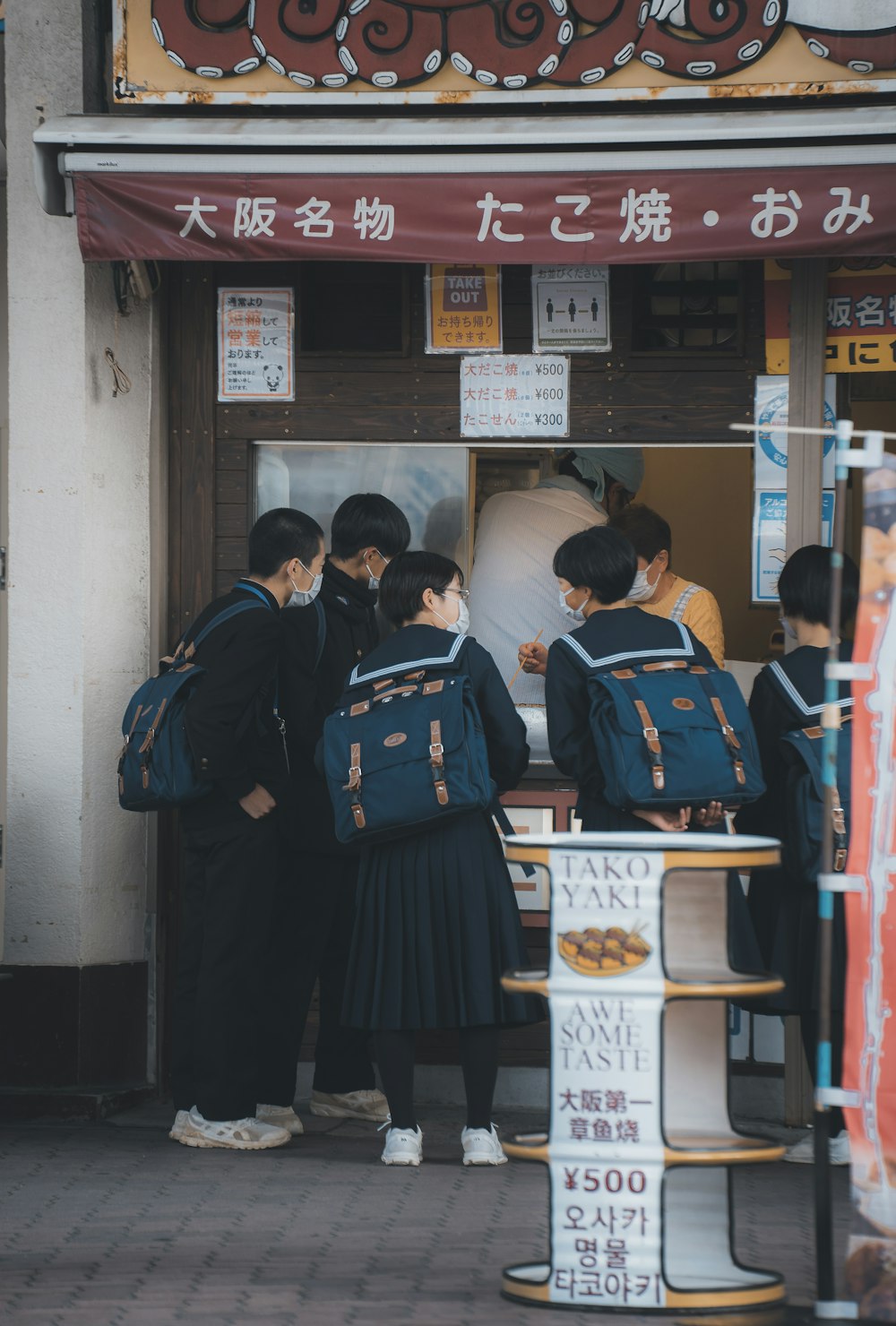 a group of people standing in front of a store