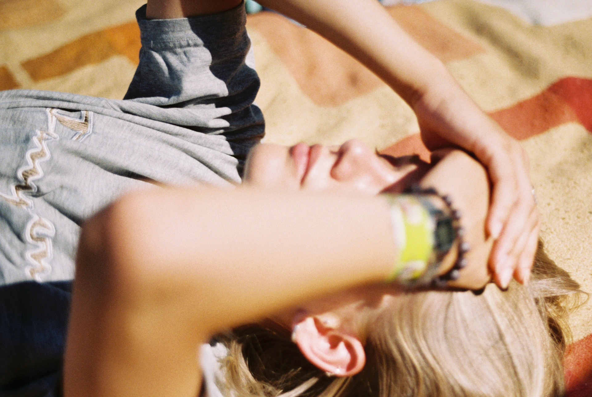 a woman laying on the ground next to a man