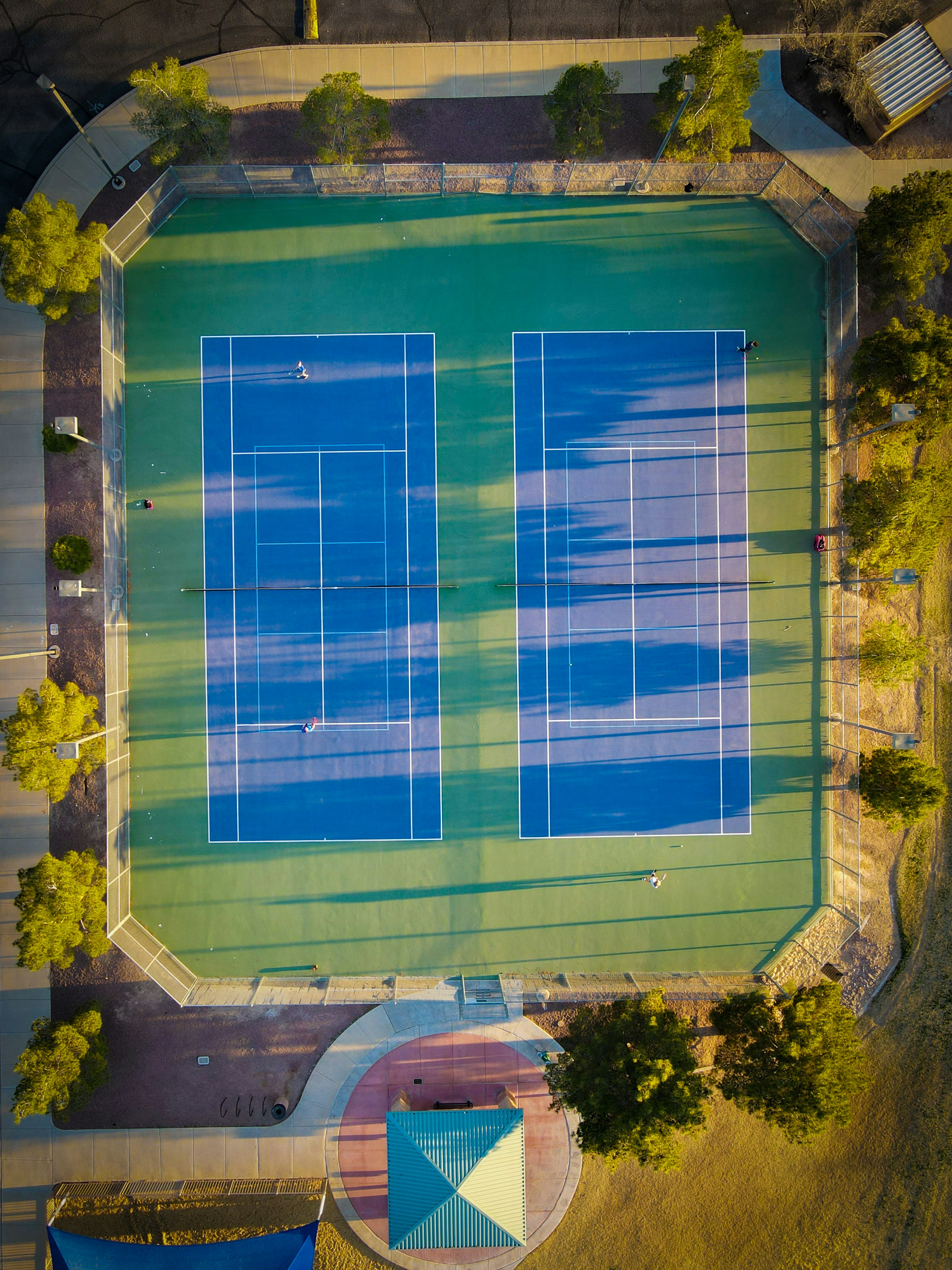 An aerial view of a tennis court with two tennis courts photo Free