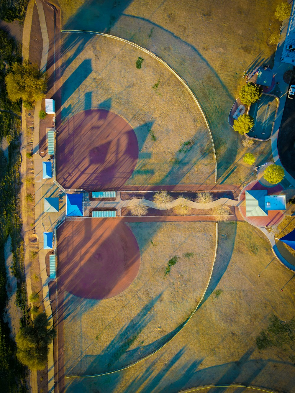 an aerial view of a park with a clock tower