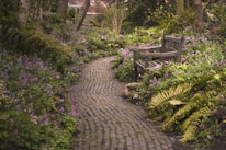 A peaceful garden corner with wildflowers and natural stone paths.