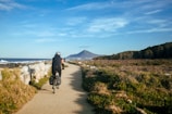 A biker riding along a coastal road with ocean views.