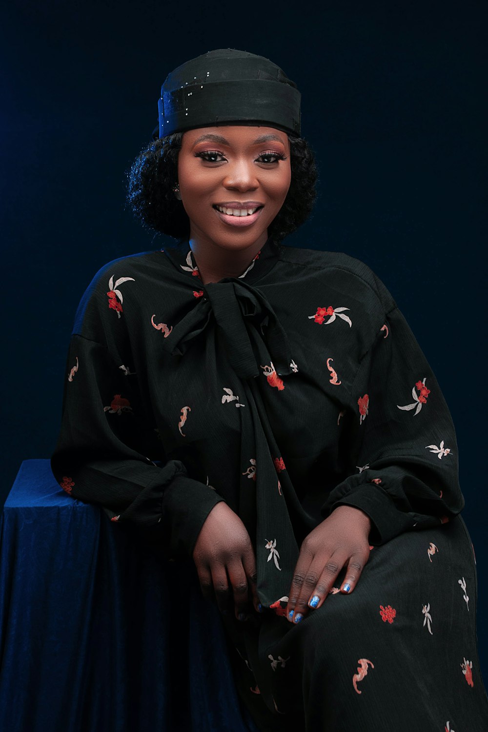 a woman sitting on top of a blue table