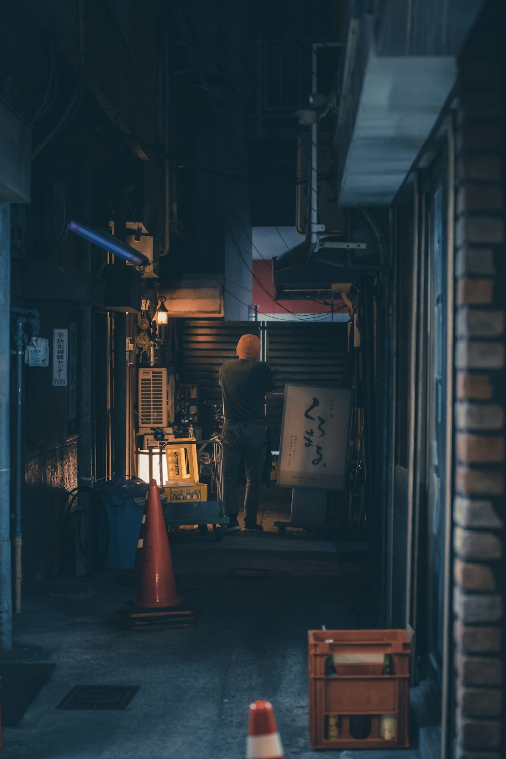 a man is standing in a dark alley