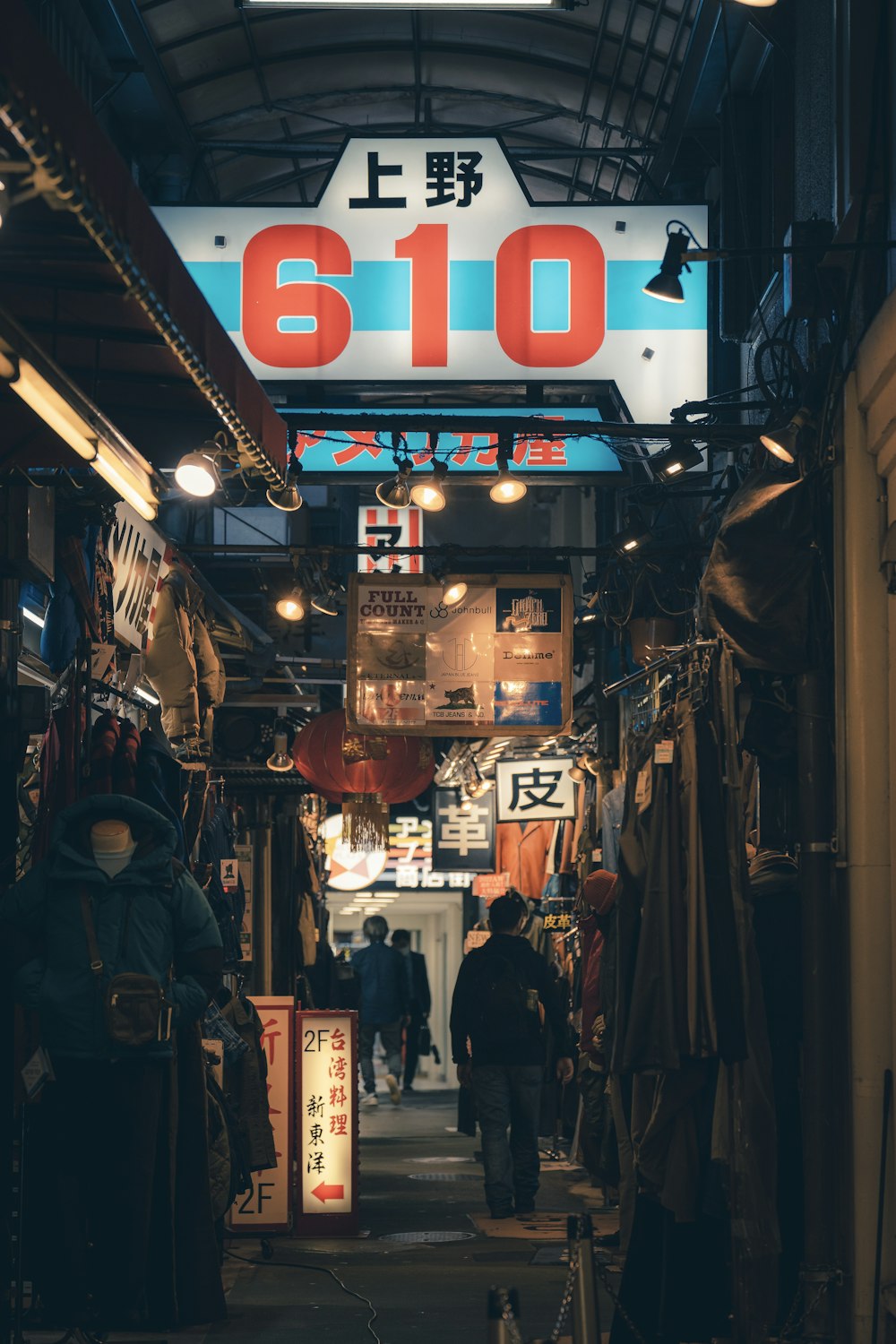 a narrow alley way with people walking through it