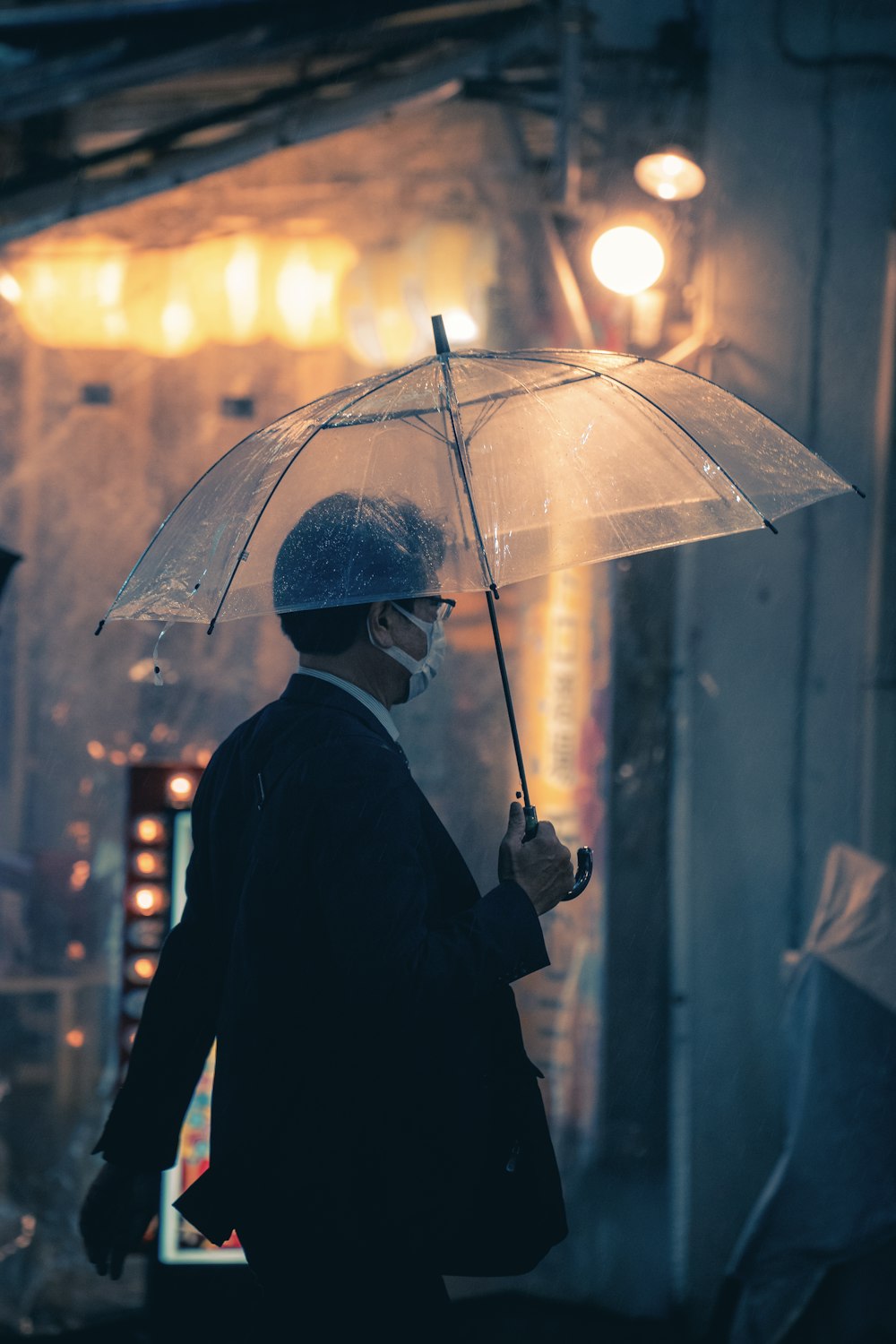 a man walking down a street holding an umbrella