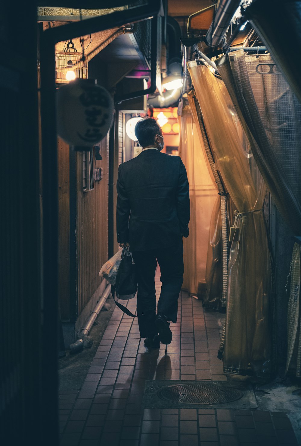 a man in a suit walking down a hallway