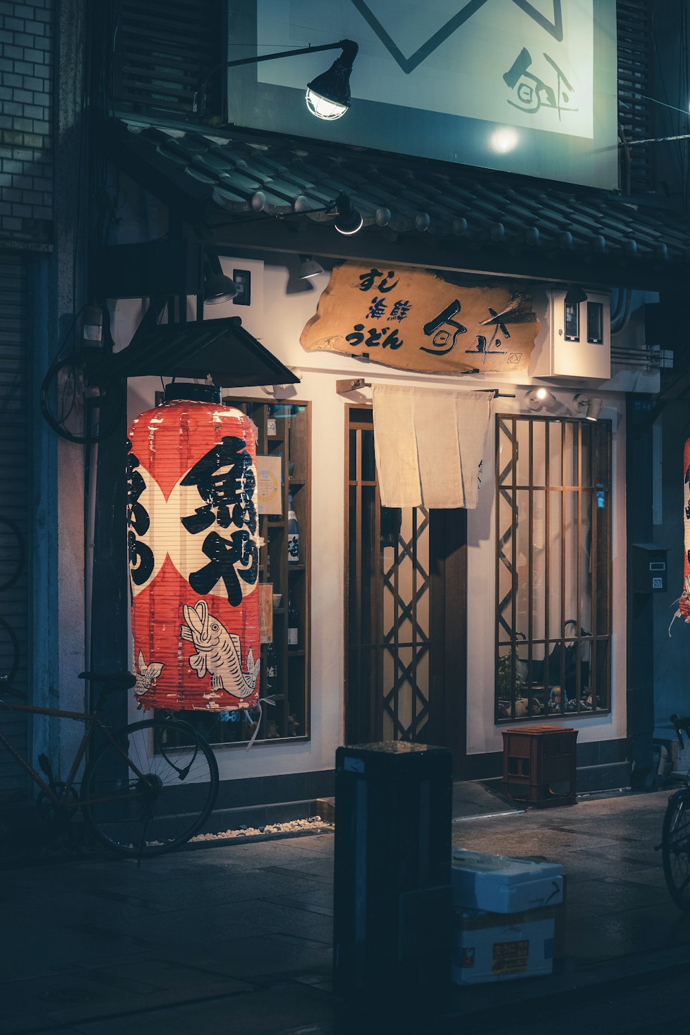 a store front with a lit up sign in front of it