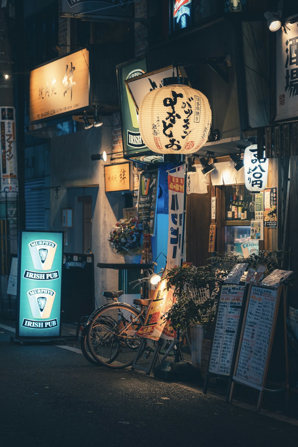 a bike parked in front of a store at night