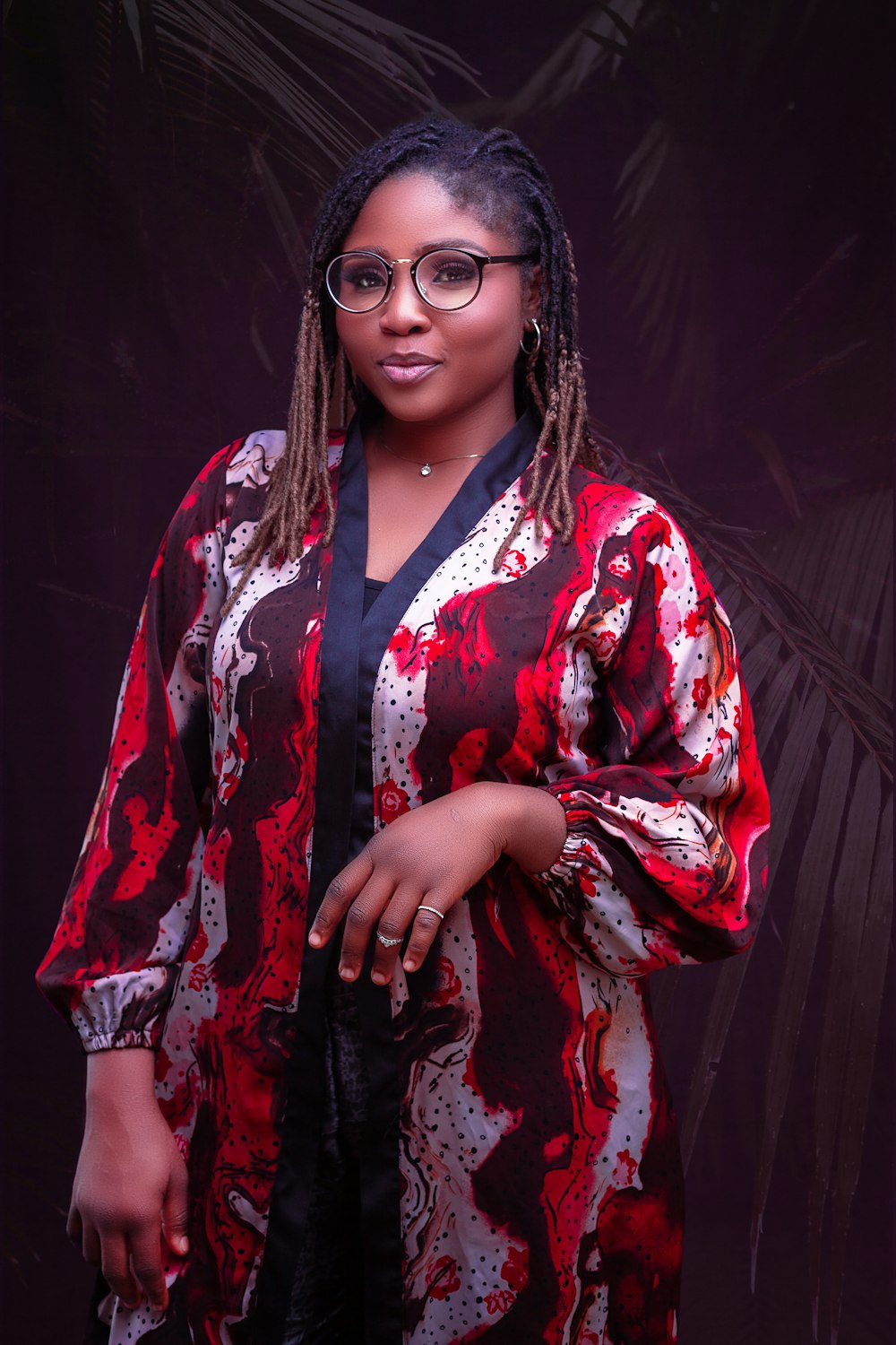 a woman wearing glasses and a red and black dress