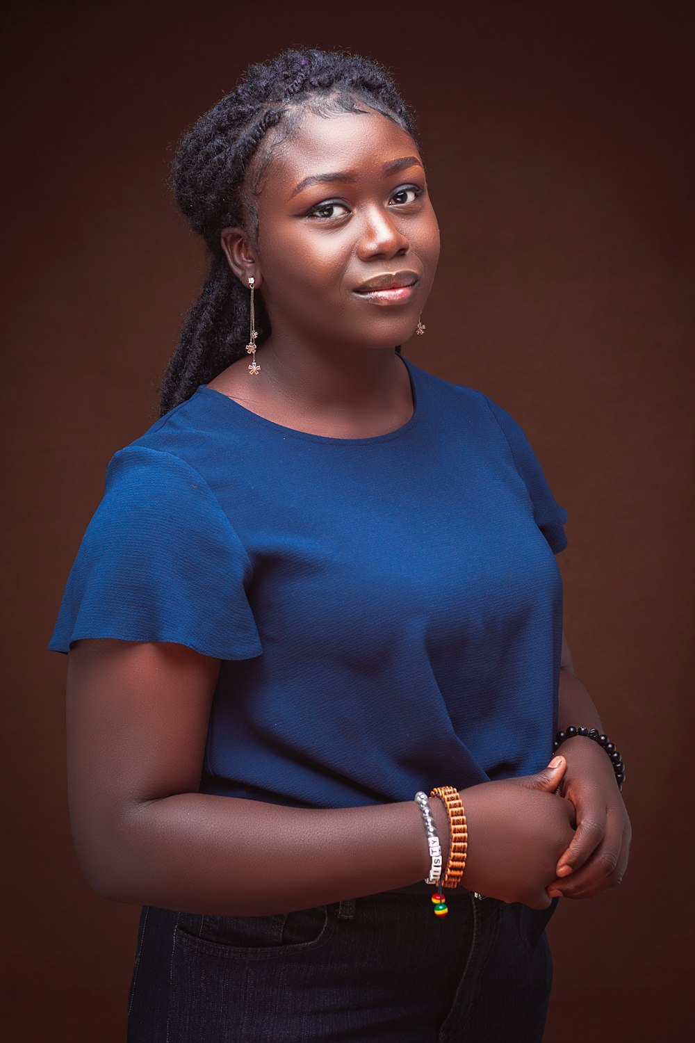 a woman in a blue shirt posing for a picture